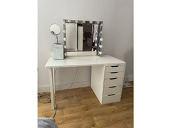 A make-up vanity with drawers and lights