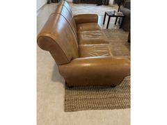 Brown leather sofa and footstool