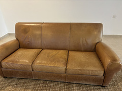 Brown leather sofa and footstool