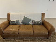 Brown leather sofa and footstool