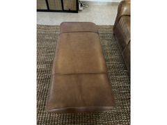 Brown leather sofa and footstool